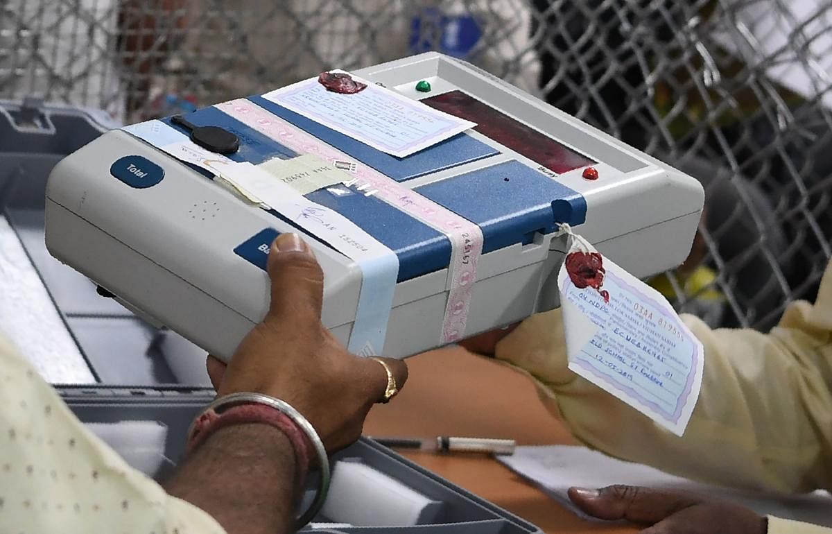 Indian election official holds an Electronic Voting Machine (EVM) at a polling counting centre. (Photo AFP)