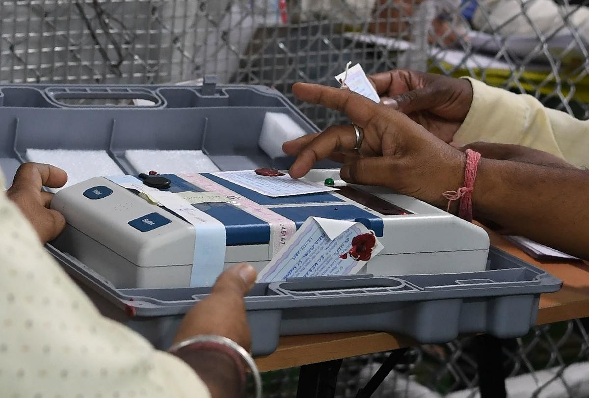 Indian election official checks an Electronic Voting Machine (EVM) at a polling counting centre in New Delhi (Photo by AFP)
