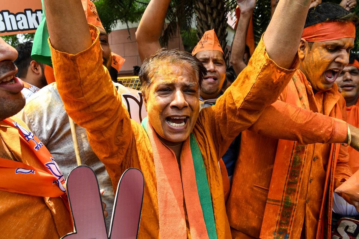 Indian Bharatiya Janata Party (BJP) supporters shout slogans as they celebrate on the vote results day for India's general election at BJP headquarters in New Delhi on May 23, 2019. - Prime Minister Narendra Modi looked on course on May 23 for a major vic