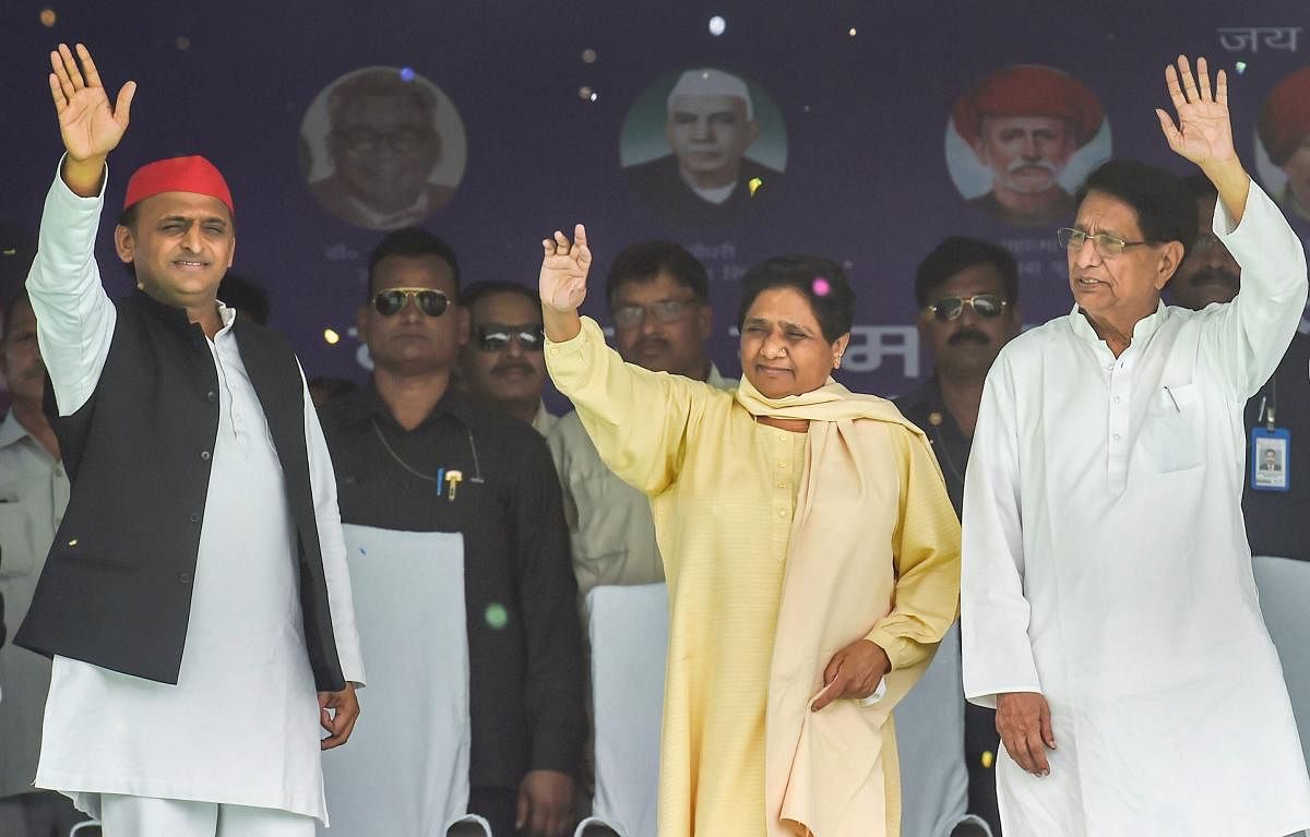 BSP chief Mayawati with Samajwadi Party chief Akhilesh Yadav, Rashtriya Lok Dal chief Ajit Singh waves at supporters at an election rally in Varanasi on May 16. PTI