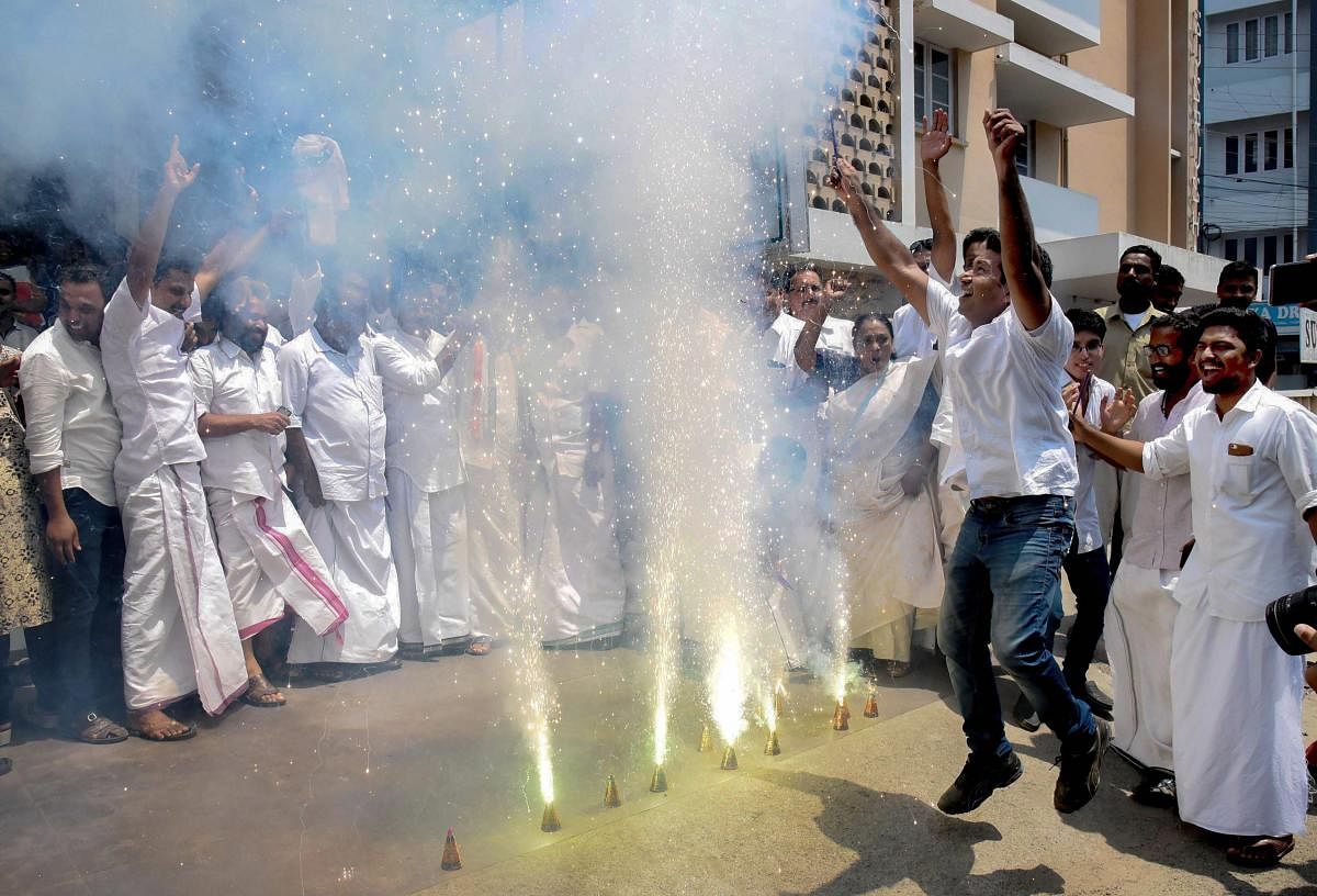 United Democratic Front supporters celebrate the party's decisive lead in the 2019 Lok Sabha polls, outside the party office in Kochi on Thursday. PTI