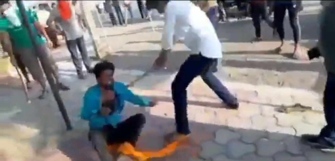 Screenshot of a man being beaten for allegedly carrying beef