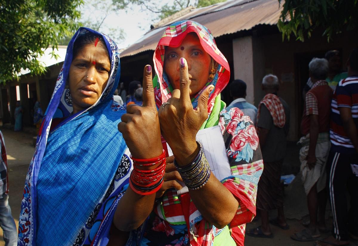 Ganjam: Voters show their finger marked with indelible ink after casting vote for the second phase of the general elections, at a polling station , Panchabhuti in Ganjam district. (PTI Photo)