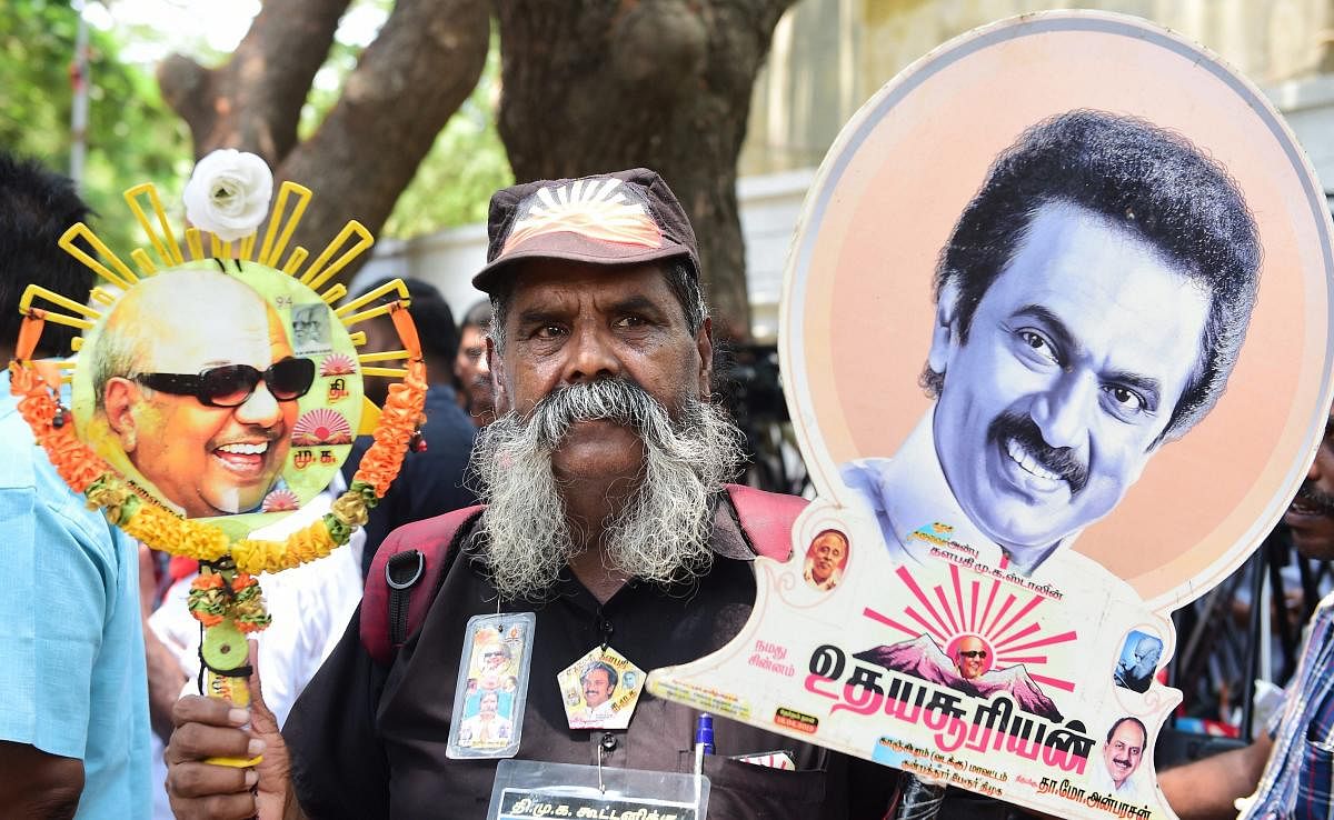 Dravida Munnetra Kazhagam (DMK) party supporter holds a photo of party President MK Stalin as he celebrates the party's win in the Lok Sabha election, in Chennai. (PTI Photo)