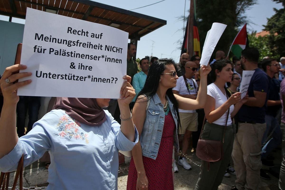 Protesters stage a demonstration outside Germany's Representative Office in Ramallah in the Palestinian West Bank on May 22, 2019, following the Bundestag's (German parliament) condemnation of the Boycott, Divestment, Sanctions (BDS) movement as anti-Semi