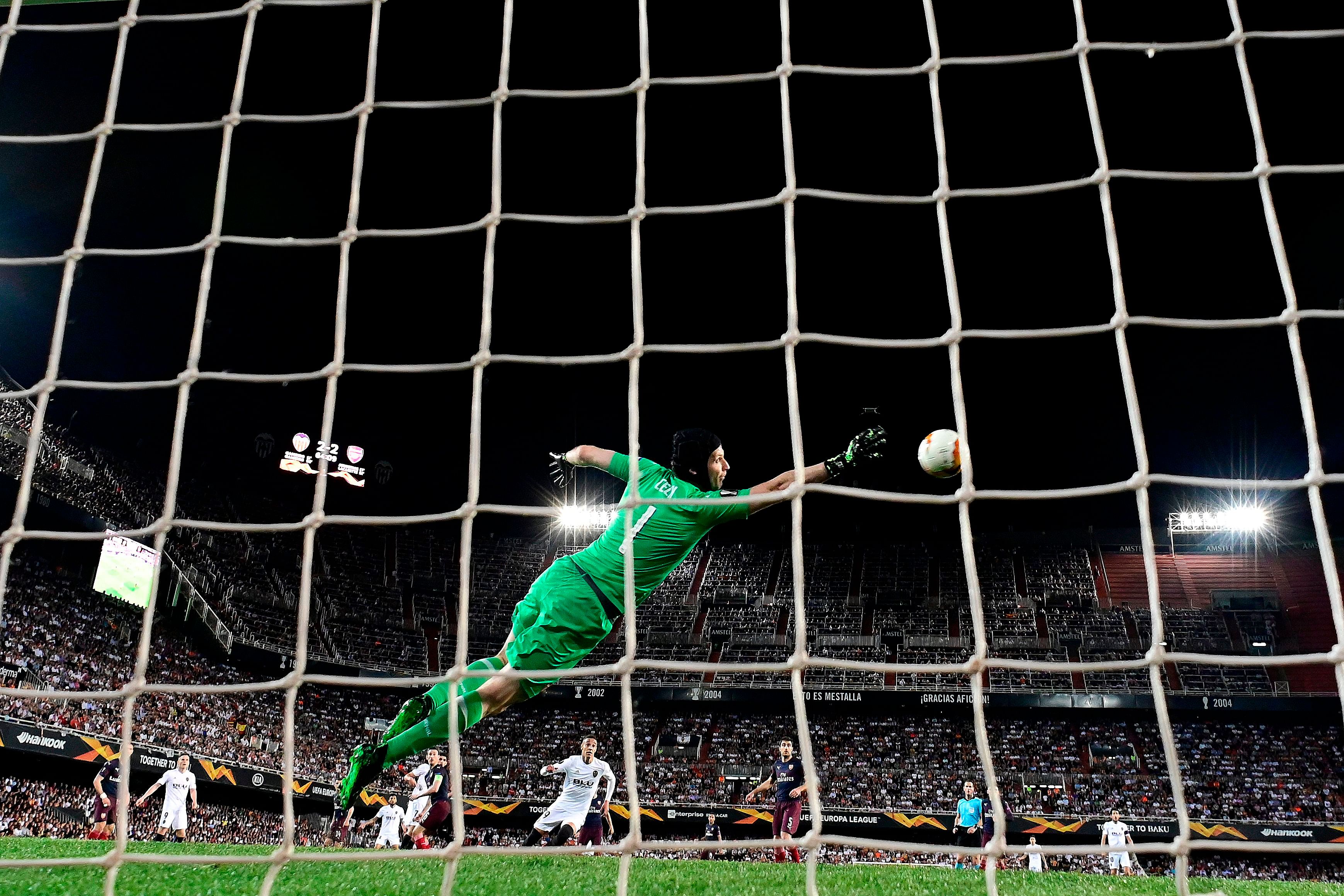 Arsenal's Czech goalkeeper Petr Cech stops a shot on goal during the UEFA Europa League semi-final second leg football match between Valencia CF and Arsenal FC at the Mestalla stadium. (Photo by AFP)