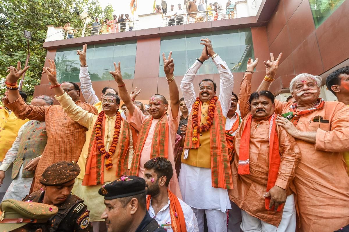Lucknow: Uttar Pradesh Chief Minister Yogi Adityanath with his Deputies Keshav Prasad Maurya and Dinesh Sharma and others celebrate the party's performance in Lok Sabha elections, at BJP office in Lucknow, Thursday, May 23, 2019. (PTI Photo/Nand Kumar)