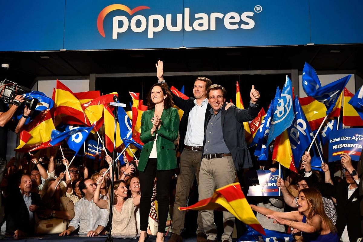 Leader of Spanish People's Party (PP), conservative Pablo Casado (C), celebrates the election results with PP candidate to Madrid's regional government Isabel Diaz Ayuso (L) and PP candidate to Madrid's mayoralty Jose Luis Martinez Almeida during an elect