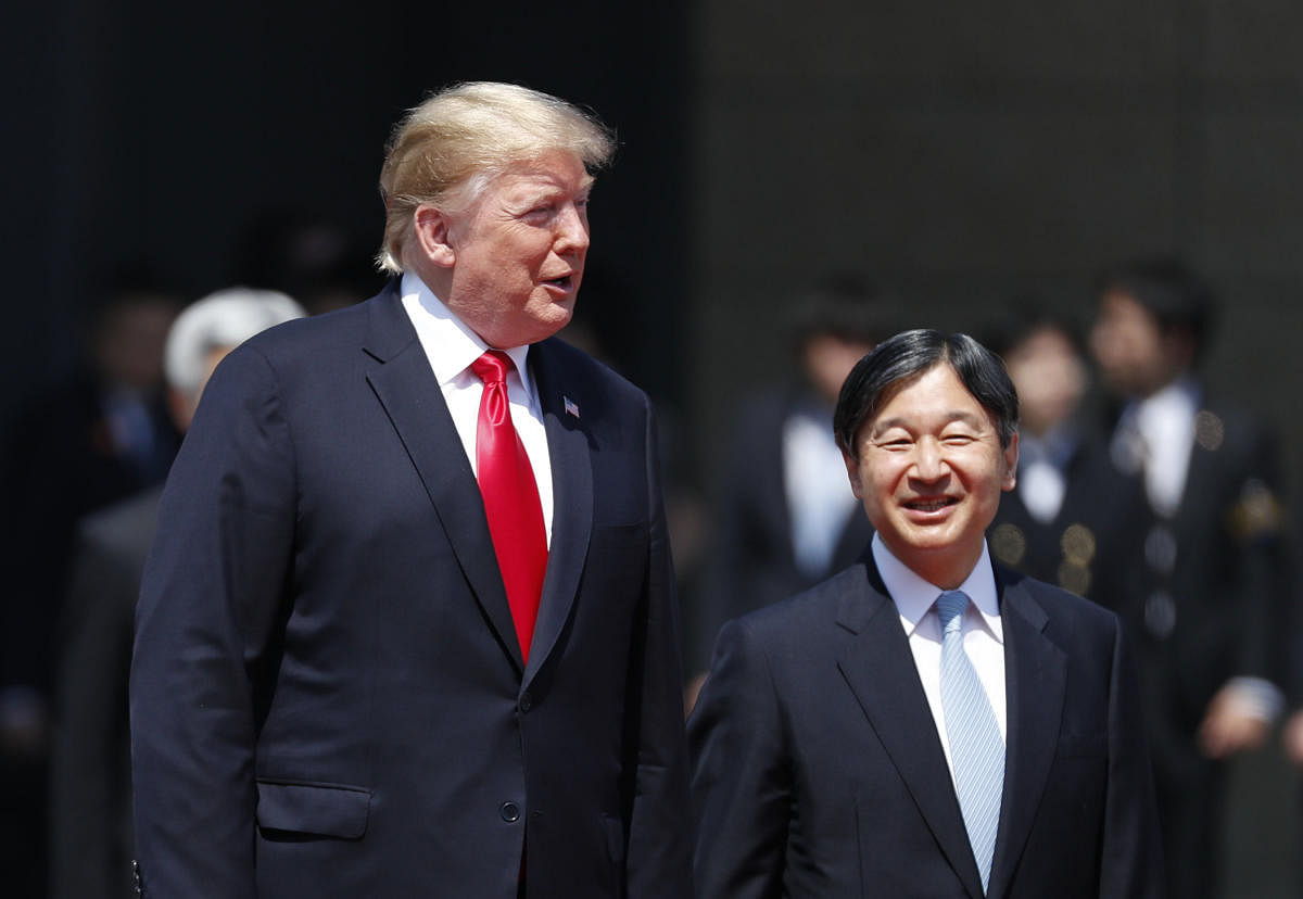 US President Donald Trump is escorted by Japan's Emperor Naruhito during a welcome ceremony at the Imperial Palace in Tokyo. (Photo by AFP)