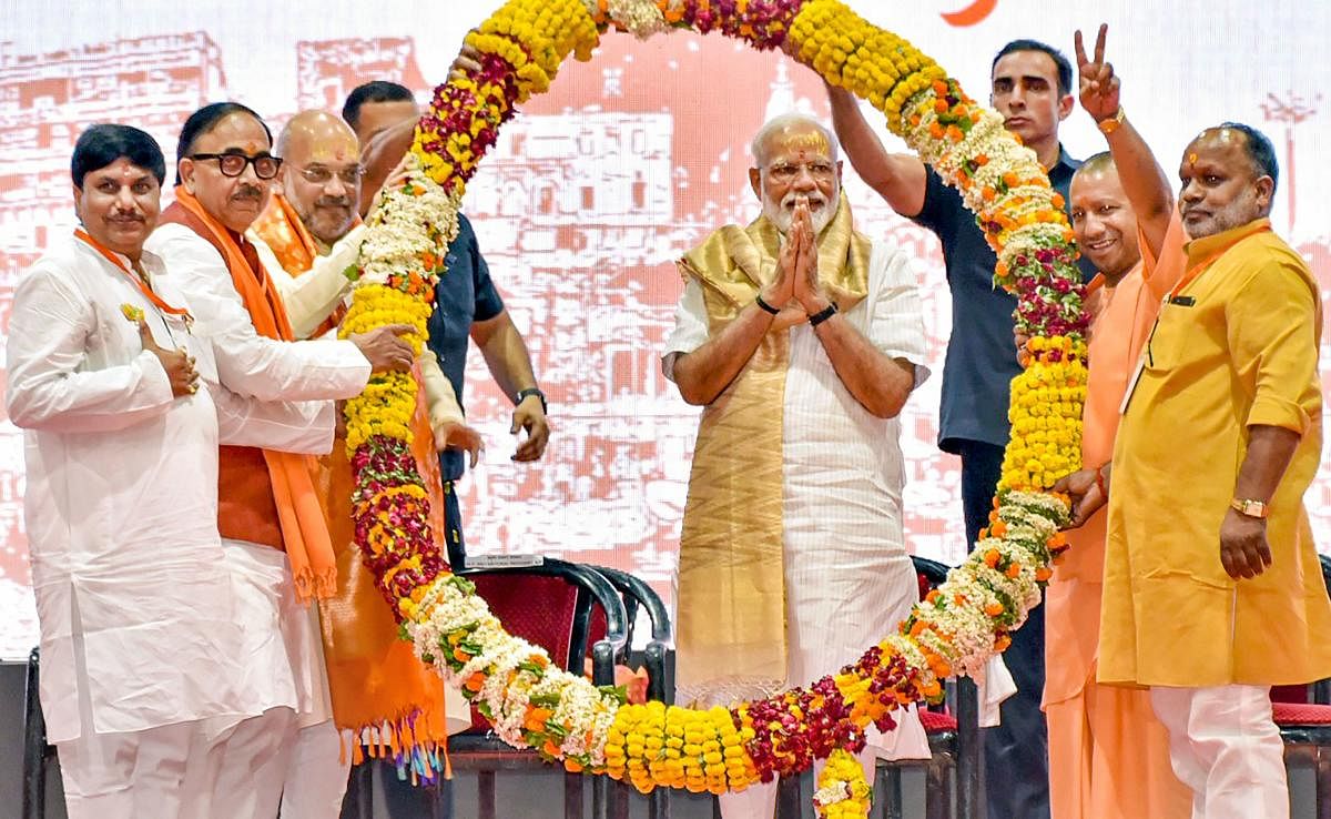 Prime Minister Narendra Modi being garlanded by BJP President Amit Shah, UP CM Yogi Adityanath, BJP UP chief Mahendra Nath Pandey and others during a meeting with the party workers at Deen Dayal Upadhyay Hastkala Sankul in Varanasi on May 27, 2019. (PTI Photo)