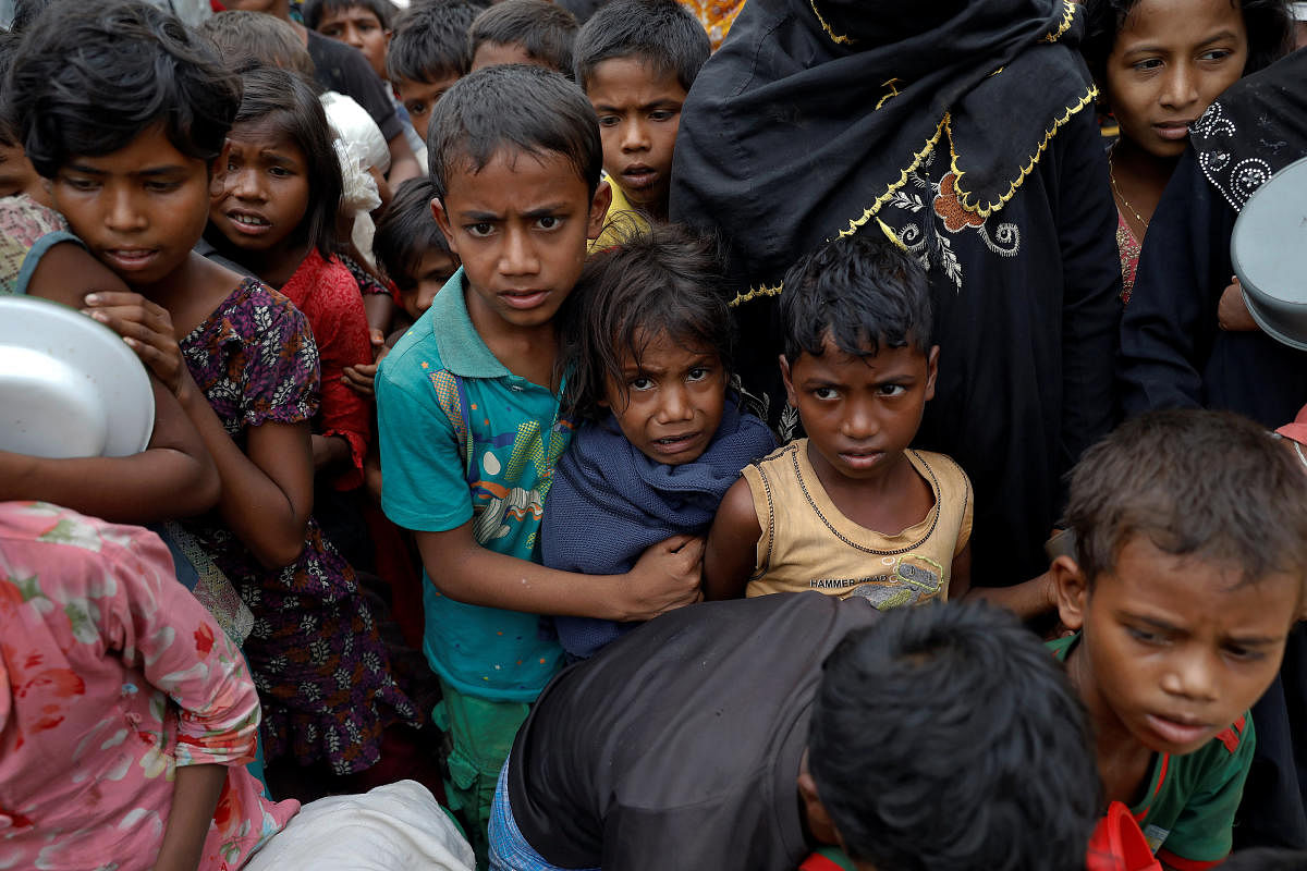 Rohingya refugees waiting for cooked food to be distributed react as volunteers try to maintain order at Tengkhali camp near Cox's Bazar, Bangladesh in December, 2017. REUTERS file photo