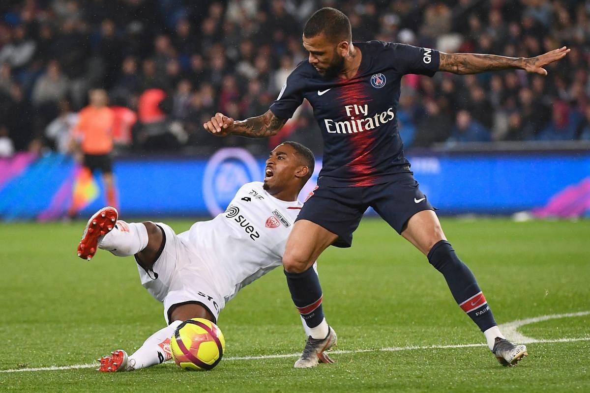 Dijon's French forward Wesley Said vies with Paris Saint-Germain's Brazilian defender Dani Alves during the French L1 football match between Paris Saint-Germain (PSG). (AFP File Photo)