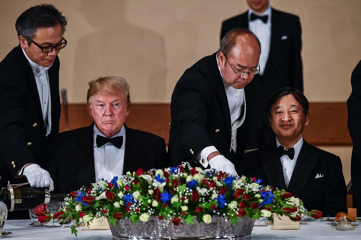 US President Donald Trump (L) and Japan's Emperor Naruhito attend a state banquet. (Photo AFP)