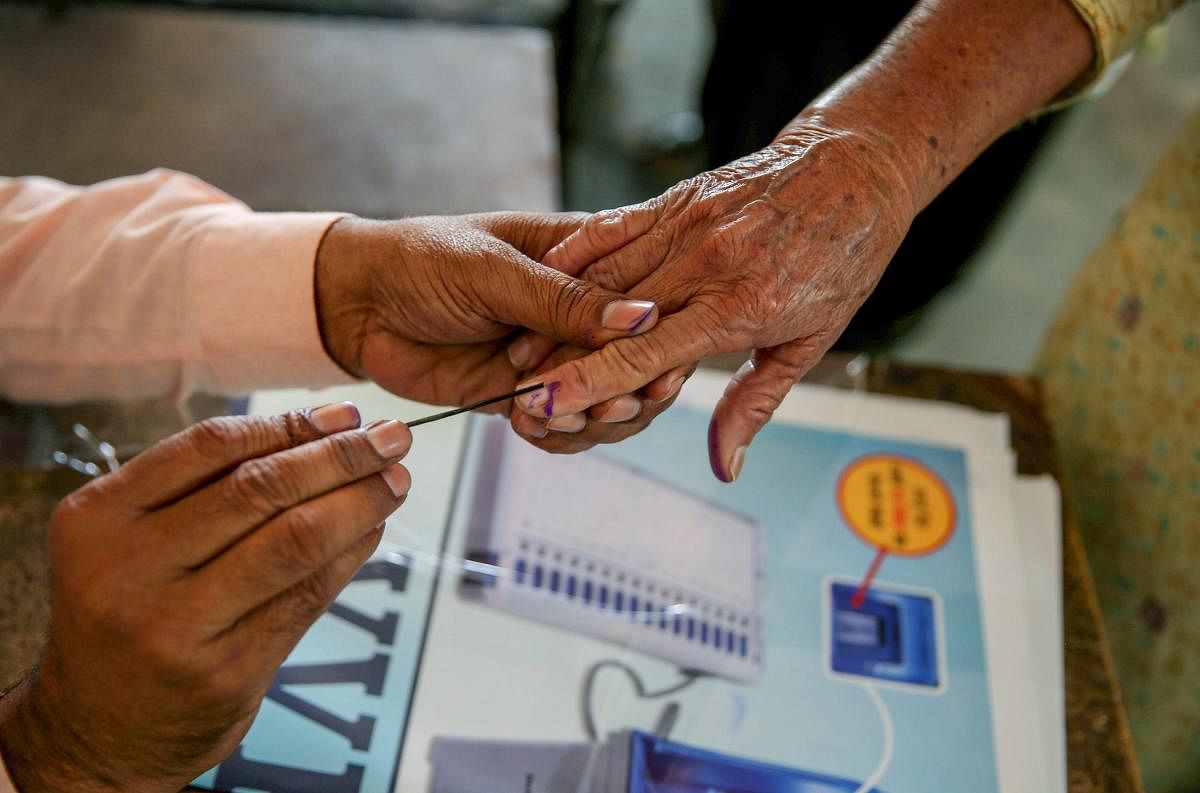 A voter gets her finger marked with indelible ink at a polling station during the seventh and last phase of Lok Sabha elections, at village Bhoot, near Amritsar on May 19, 2019. (PTI)