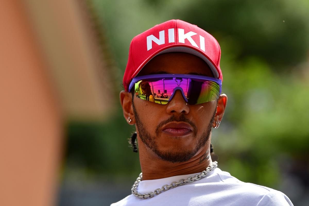 Mercedes' British driver Lewis Hamilton wearing a red cap in tribute late Formula One legend Niki Lauda looks on ahead of the Monaco Formula 1 Grand Prix at the Monaco street circuit. (Photo AFP)