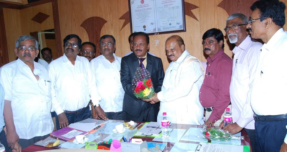 M S Mahadeva Nayak takes charge as special officer of Mandya University. MLA M Srinivas looks on. DH Photo