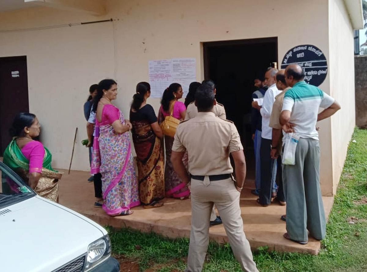Voters wait in a queue at ward 11 of Mudigere Town Panchayat.