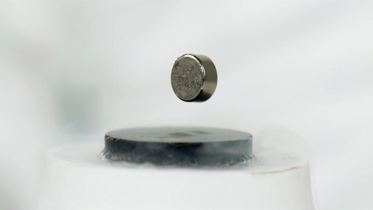 A superconducting material levitates after repelling magnetic fields due to the Meissner effect. YOUTUBE