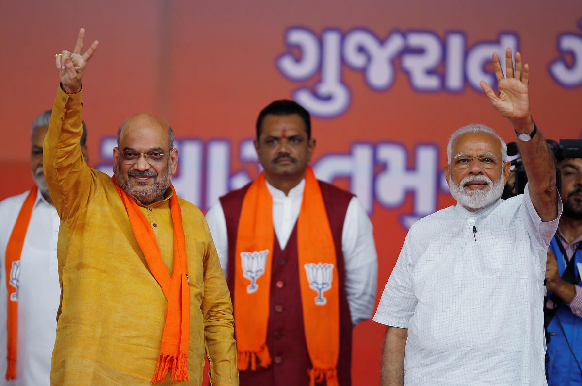 India's Prime Minister Narendra Modi and Bharatiya Janata Party (BJP) President Amit Shah wave toward their supporters at a public meeting in Ahmedabad, India, May 26, 2019. REUTERS