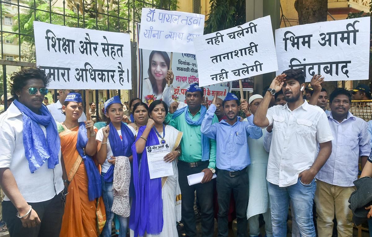 Members of Bhim Army hold placards and shout slogan during a protest against the suicide of post-graduate medical student Payal Tadvi, outside Nair Hospital in Mumbai. (PTI Photo)