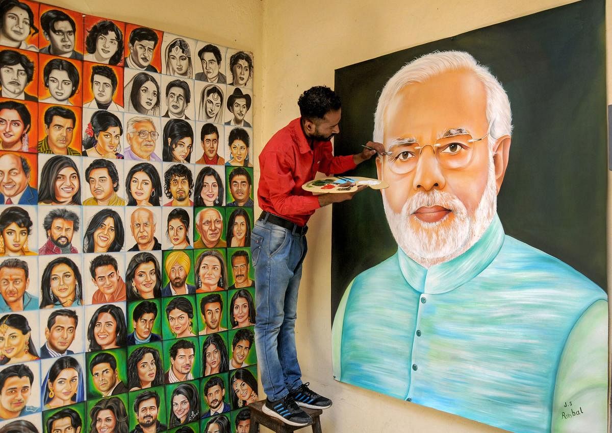 An artist adds details to a portrait of Prime Minister Narendra Modi ahead of his swearing-in ceremony for the second term as Prime Minister of India, in Amritsar, Wednesday, May 29, 2019. (PTI Photo)