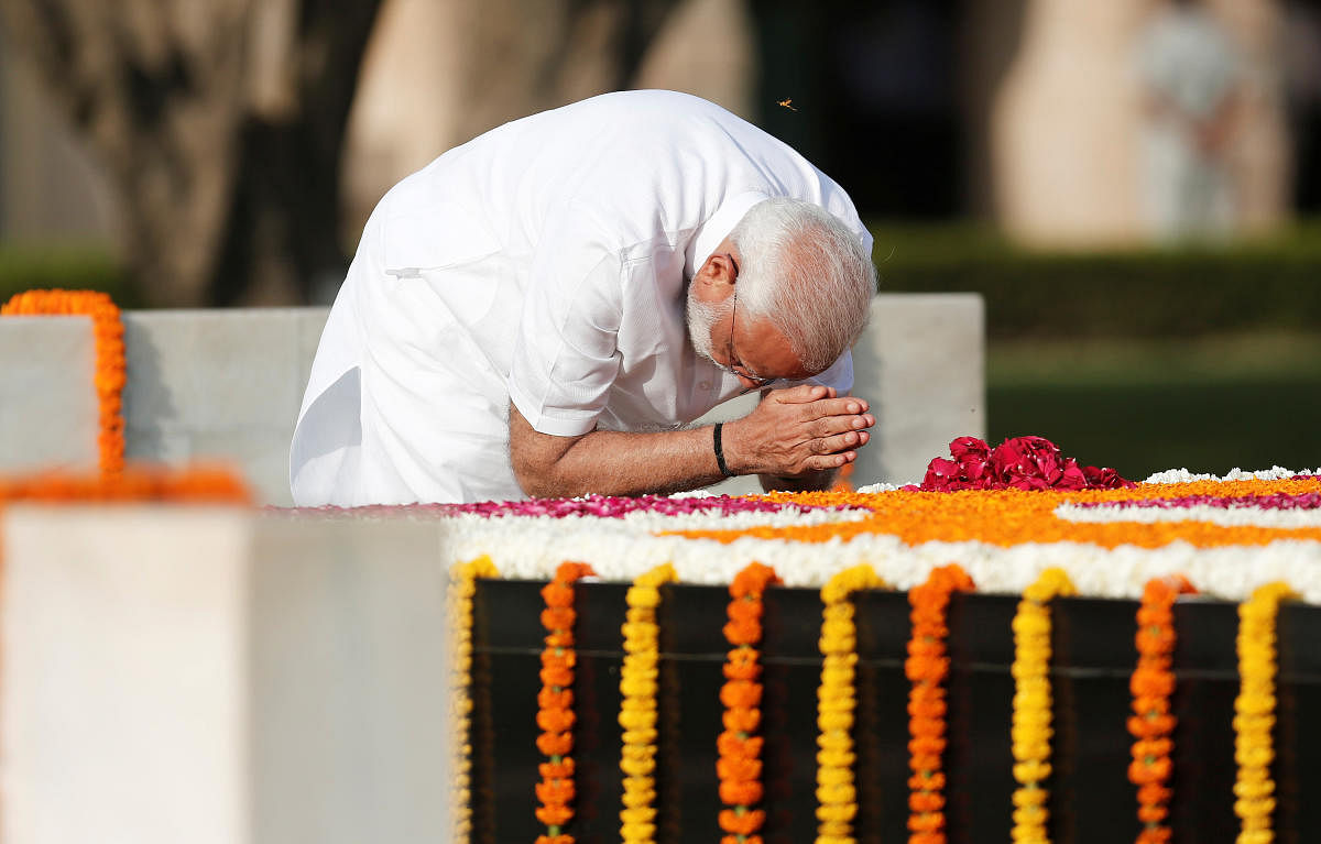 India's Prime Minister Narendra Modi pays his respects at the Mahatma Gandhi memorial at Raj Ghat ahead of his swearing-in ceremony, in New Delhi. (Reuters Photo)