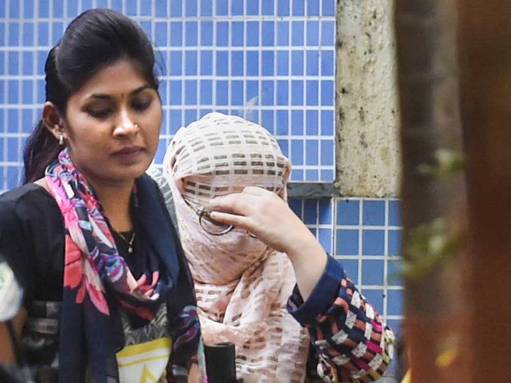 One of the three doctors accused in Payal Tadvi suicide case (face covered) being taken to the court from Nagpada Police station, in Mumbai on Friday. PTI photo