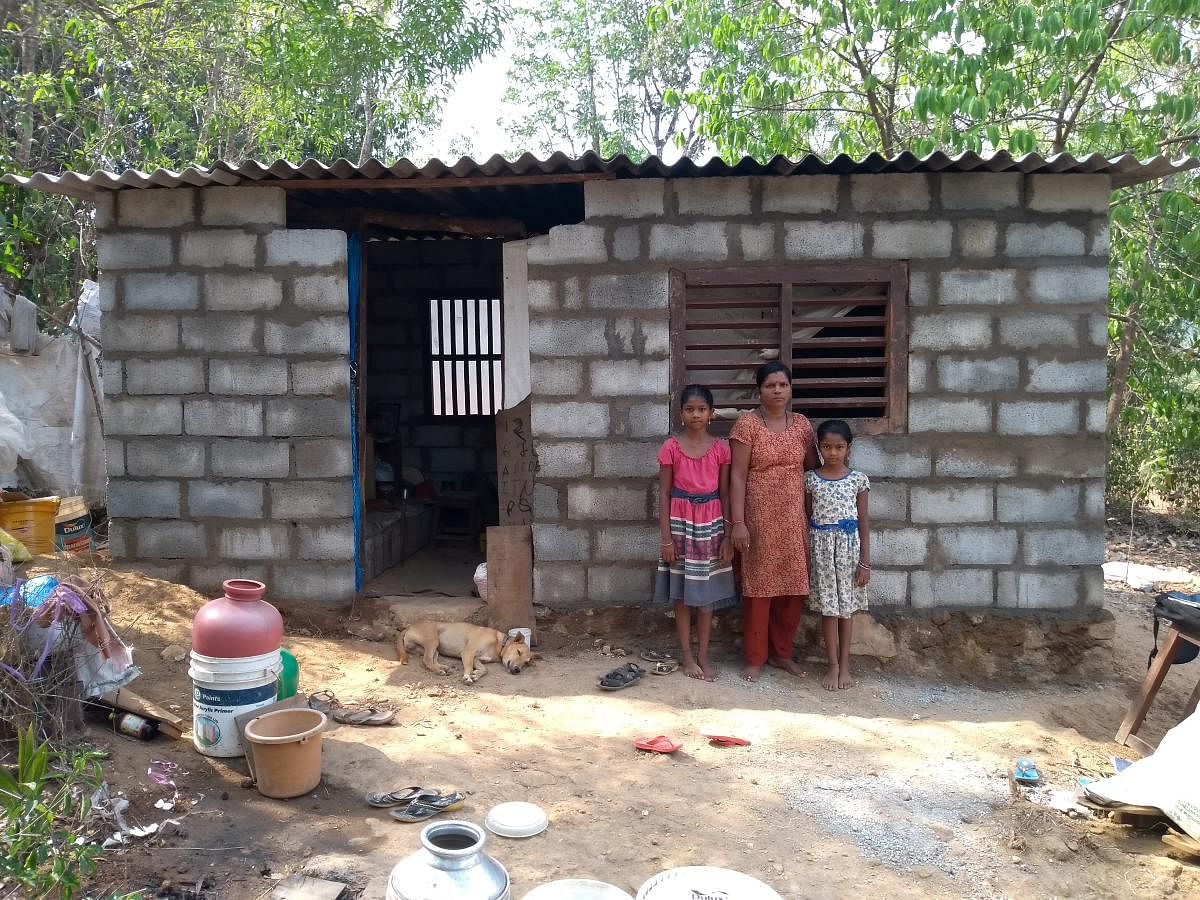 Vanaja and her children in front of the house in Hatyadka on the outskirts of Naravi in Beltangady taluk.
