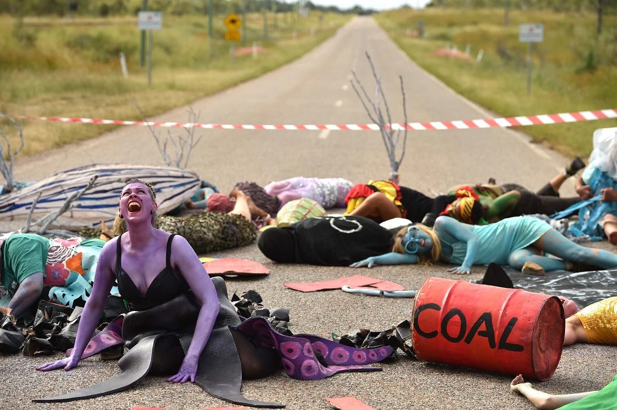 In this photo taken on May 1, 2019 shows environmental campaigners holding a protest against the development of the India-backed Adani coal mine at the entrance of Abbot Point port near the Queensland state town of Bowen, where the commodity will be shipp
