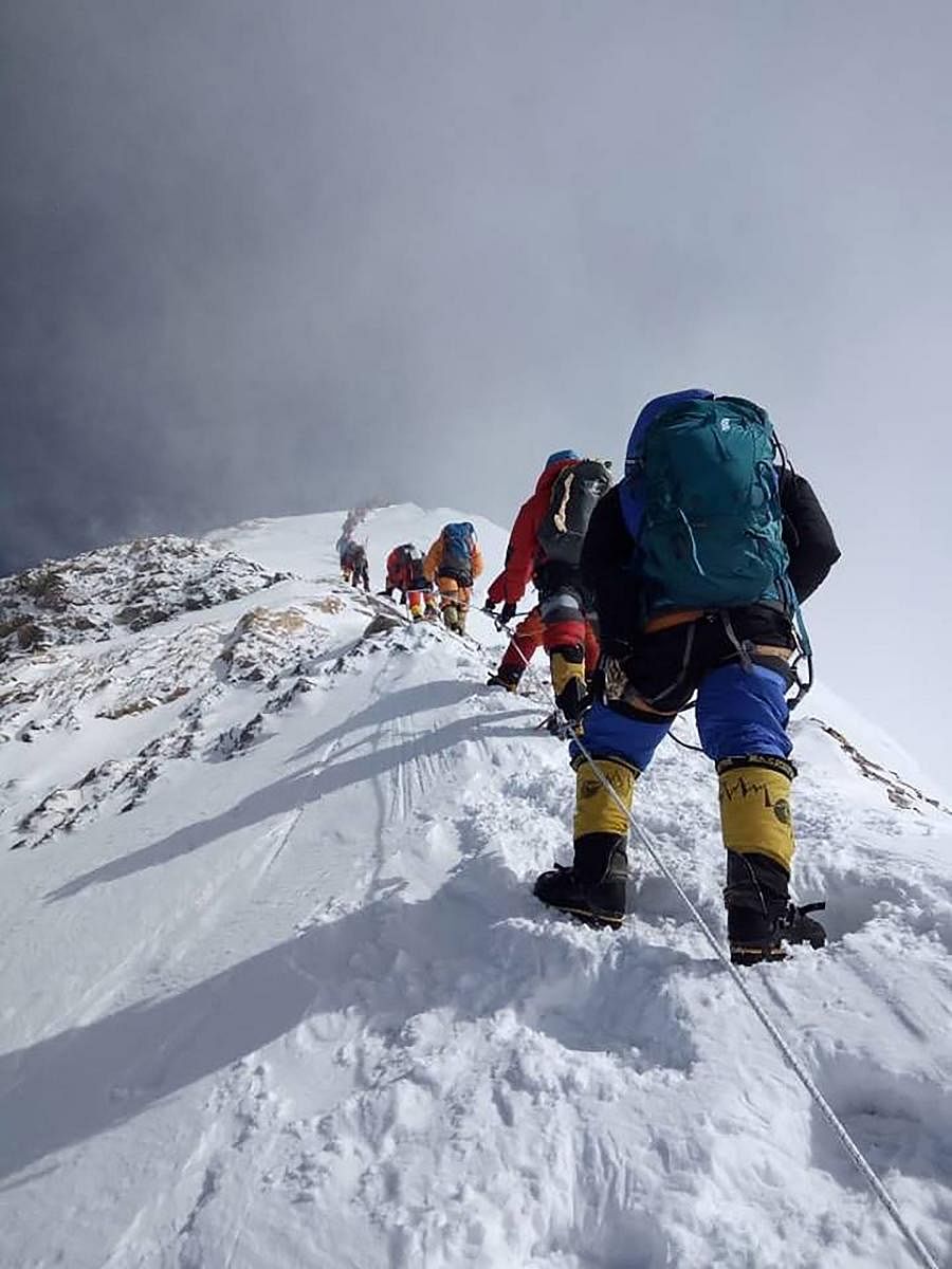 In this file photo taken on May 16, 2018, mountaineers ascend on their way to the summit of Mount Everest, as they climb on the south face from Nepal. AFP
