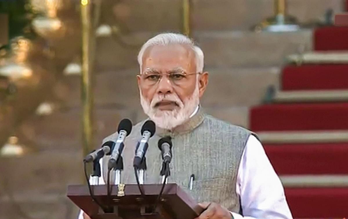 Prime Minister Narendra Modi takes oath of office and secrecy for the second consecutive term, at the swearing-in ceremony at forecourt of Rashtrapati Bhavan in New Delhi on Thursday. PTI file photo