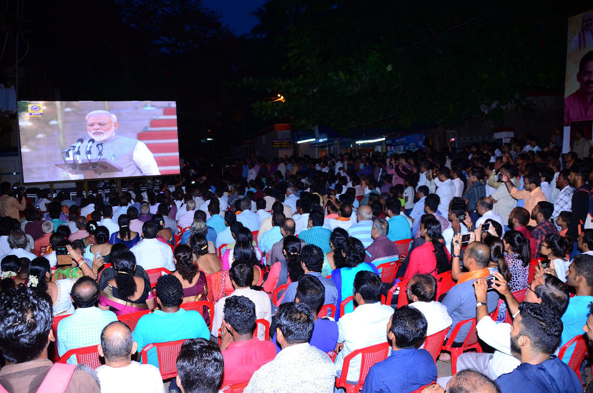Audience at the screening of Prime Minister Narendra Modi’s swearing-in ceremony organised near BJP’s office at PVS  Circle, Mangaluru on Thursday evening.