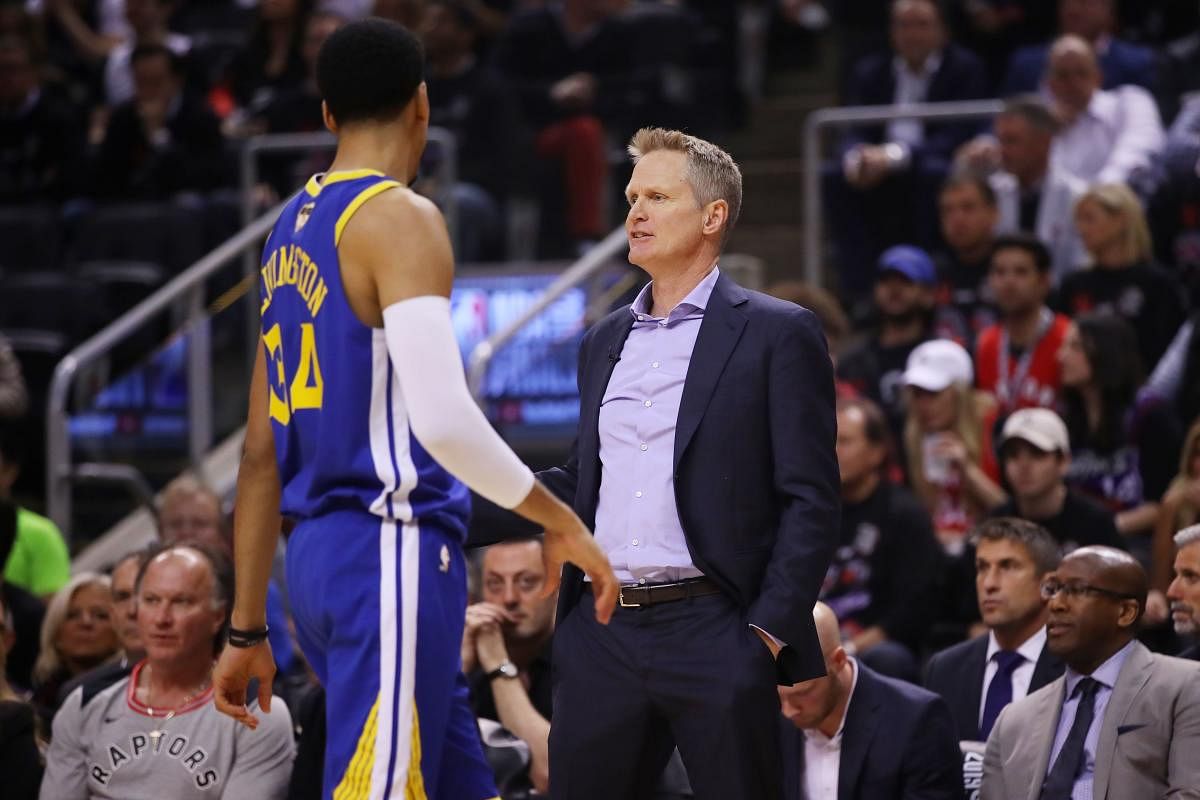 Head coach Steve Kerr of the Golden State Warriors speaks with Shaun Livingston #34 during a timeout against the Toronto Raptors in the second quarter during Game One of the 2019 NBA Finals at Scotiabank Arena on May 30, 2019 in Toronto, Canada. (photo by