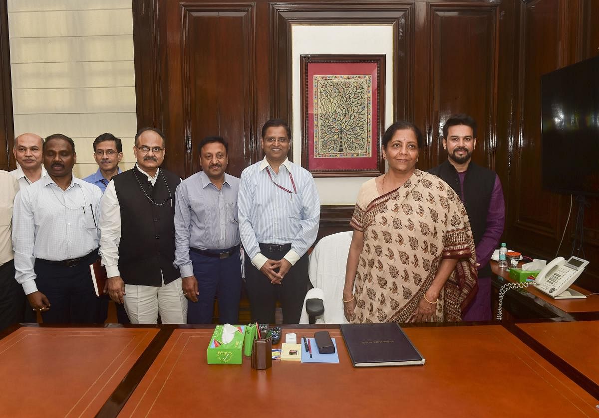 Newly appointed Finance Minister Nirmala Sitharaman takes charge at South Block, in New Delhi, Friday, May 31, 2019. Also seen is newly appointed MoS Finance and Corporate Affairs Anurag Singh Thakur. PTI photo