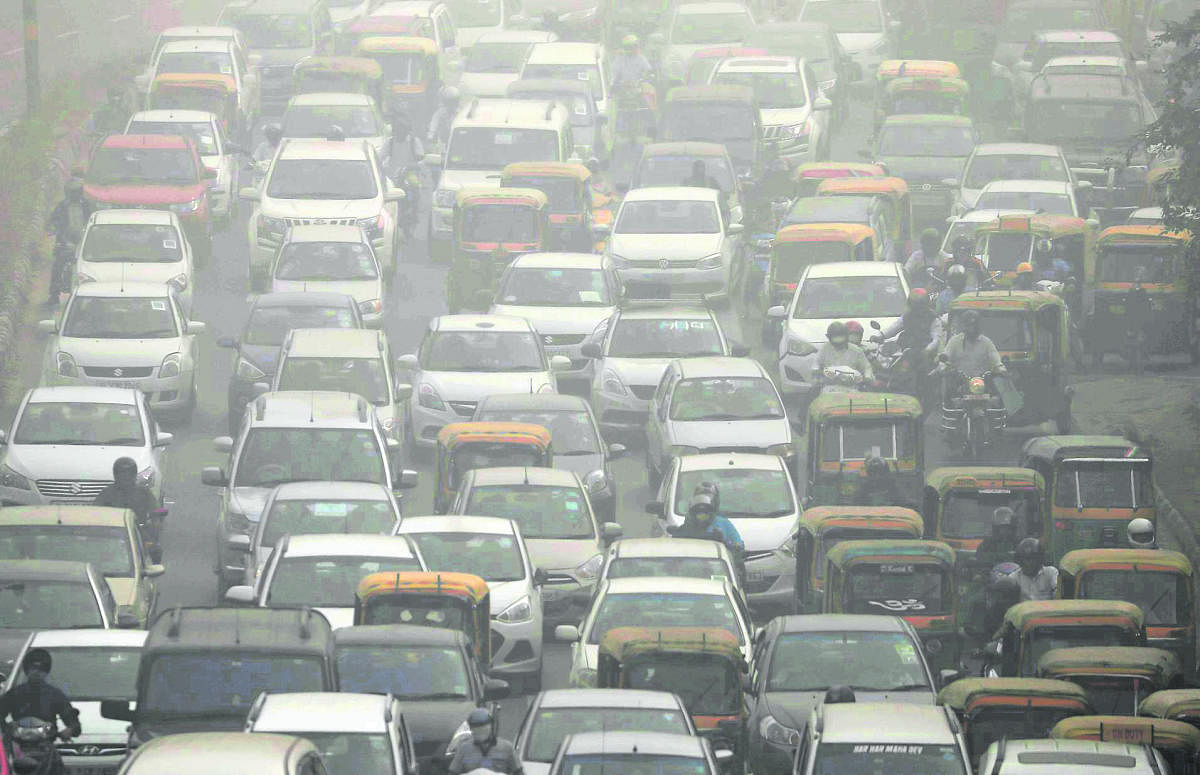 Blanket of threat: Vehicles drive through heavy smog in Delhi. REUTERS