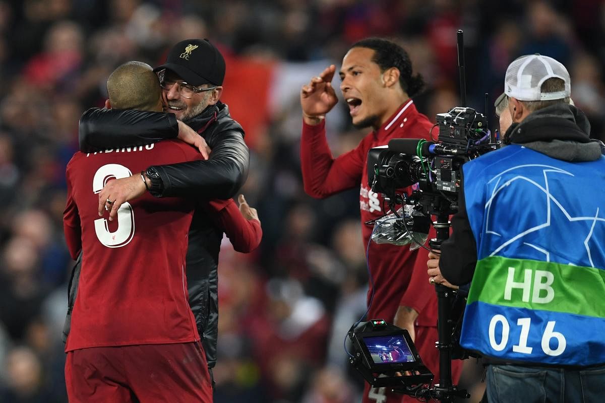Liverpool's German manager Jurgen Klopp celebrates with Liverpool's Brazilian midfielder Fabinho after winning the UEFA Champions League semi-final second leg football match between Liverpool and Barcelona at Anfield in Liverpool. (AFP File Photo)