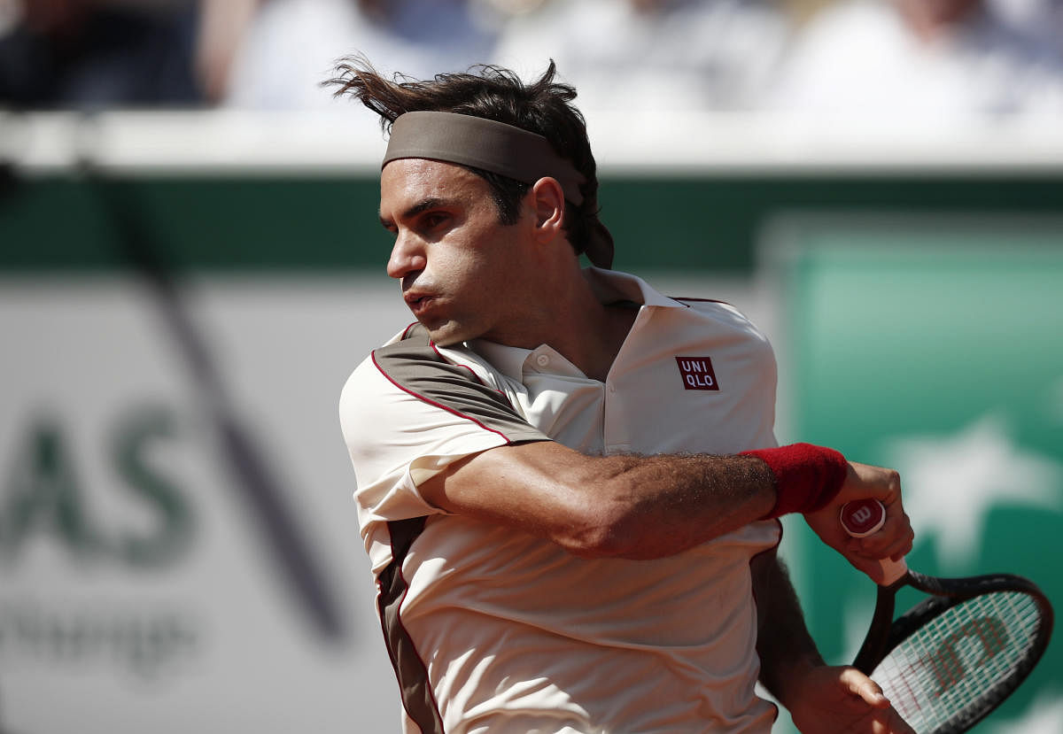 ANOTHER RECORD Roger Federer returns during his win over Casper Ruud on Friday. REUTERS