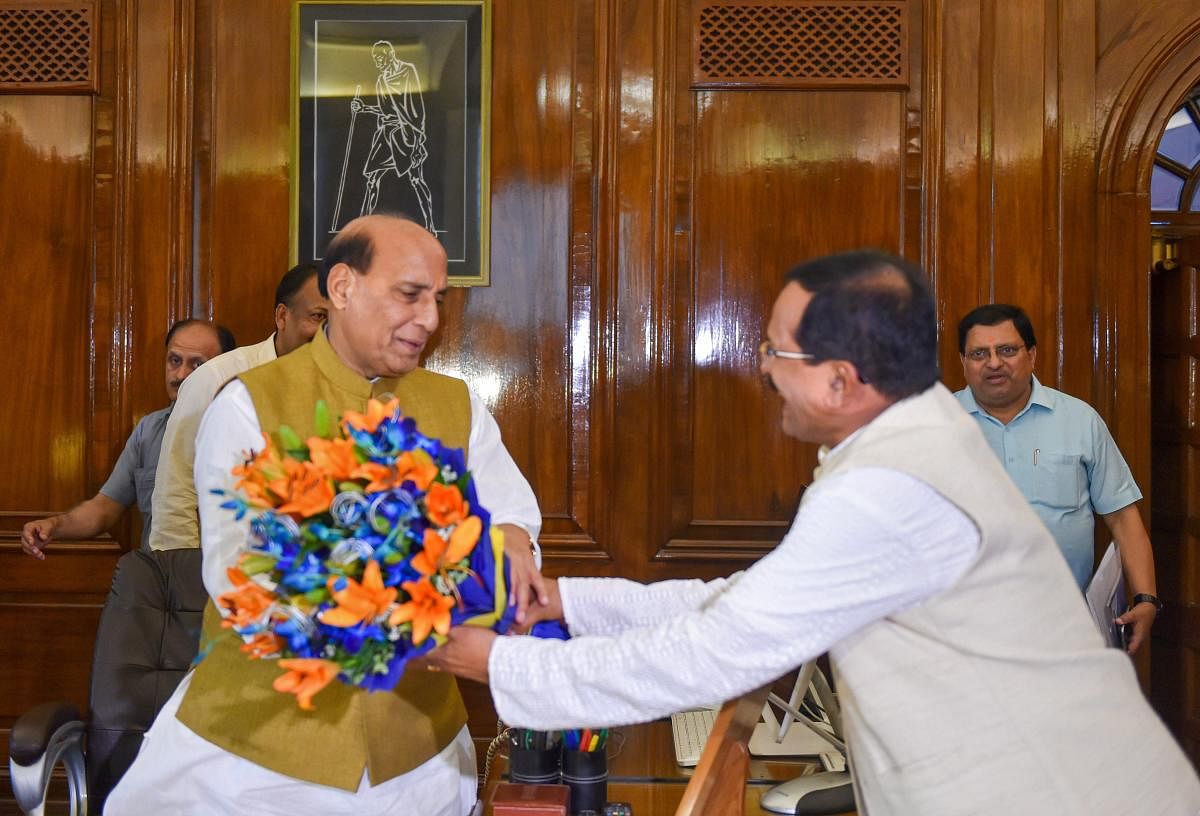 Rajnath Singh takes charge as Minister of Defence in newly-elected PM Modi's cabinet, at South Block in New Delhi on Saturday. PTI file photo