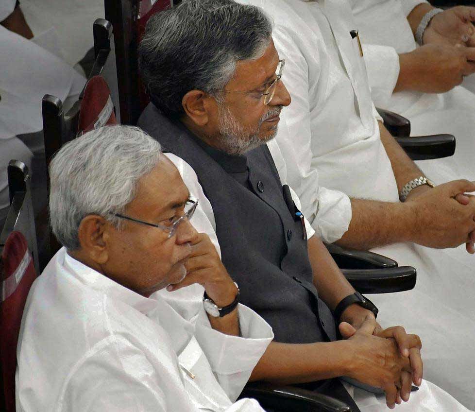Bihar Chief Minister Nitish Kumar with his deputy Sushil Kumar Modi during the swearing-in ceremony for the cabinet expansion of coalition government of NDA in Patna on Sunday. PTI Photo