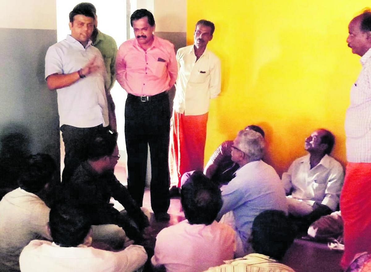 Belthangady MLA Harish Poonja is seen addressing parents staging a protest at the day care centre for endosulfan victims at Kokkada in Beltangady taluk on Saturday.