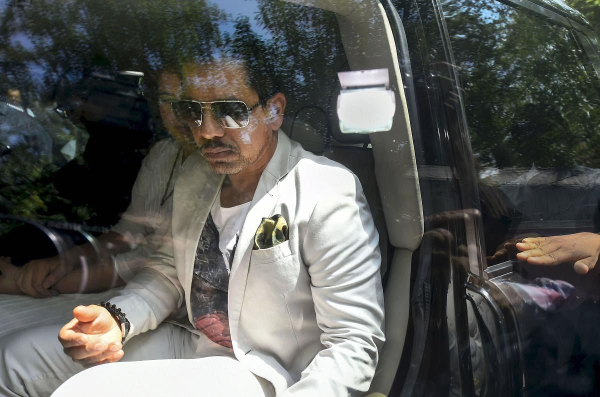 Businessman Robert Vadra arrives at the Enforcement Directorate (ED) office for questioning in connection with a money laundering case, in New Delhi, Thursday, May 30, 2019. Congress General Secretary Priyanka Gandhi Vadra is also seen. (PTI Photo)