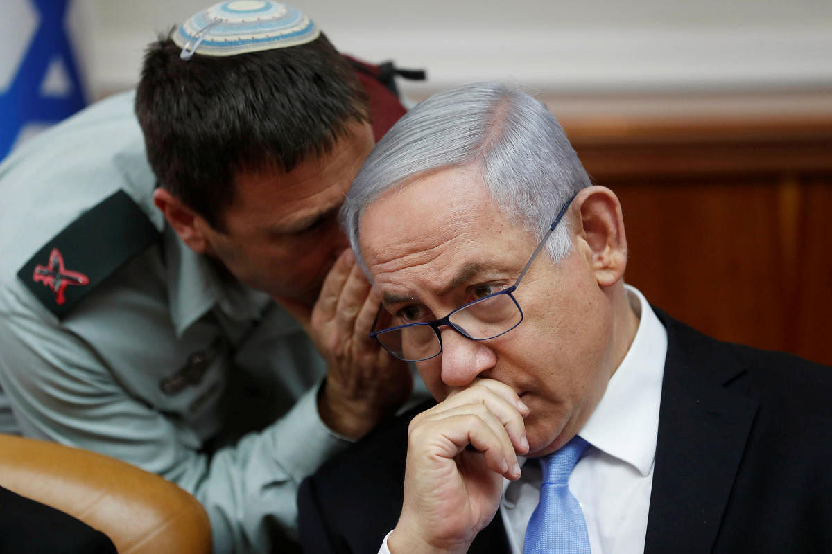 Israeli Prime Minister Benjamin Netanyahu listens to Brigadier General Avi Blot, his military secretary, during the weekly cabinet meeting in Jerusalem on June 2, 2019. REUTERS