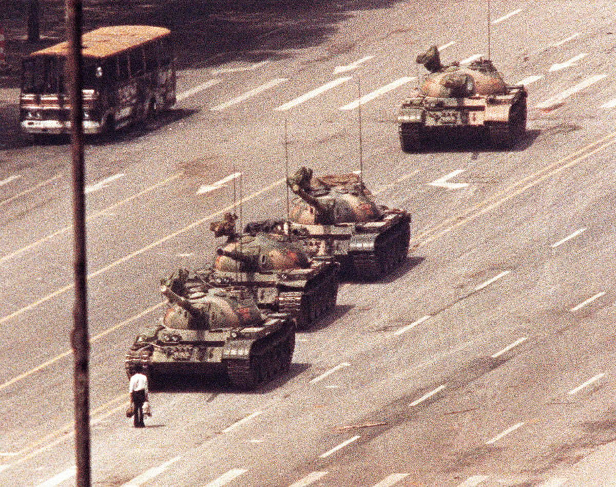 A man stands in front of a convoy of tanks in the Avenue of Eternal Peace in Beijing, China, June 5, 1989. (REUTERS/Arthur Tsang/File Photo)