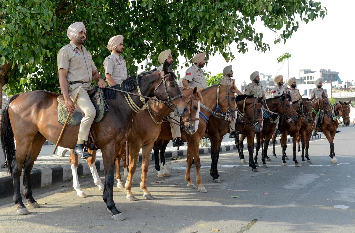 Indian Punjab Police personnel ride horses to patrol on the streets on the eve of the 35th Operation Blue Star Anniversary in Amritsar on June 5, 2019. - The Indian military's June 1984 assault on the Golden Temple in Amritsar, called Operation Blue Star, was aimed at flushing out militants holed up inside demanding an independent Sikh homeland.  AFP photo
