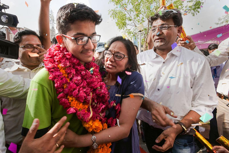 All India National Eligibility cum Entrance Test (NEET) topper Nalin Khandelwal celebrates with his parents after the declaration of results in Jaipur. (PTI Photo)