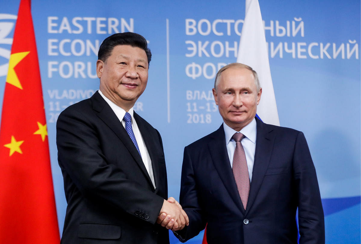 Russian President Vladimir Putin shakes hands with Chinese President Xi Jinping during their meeting on the sidelines of the Eastern Economic Forum in Vladivostok, Russia on September 11, 2018. REUTERS