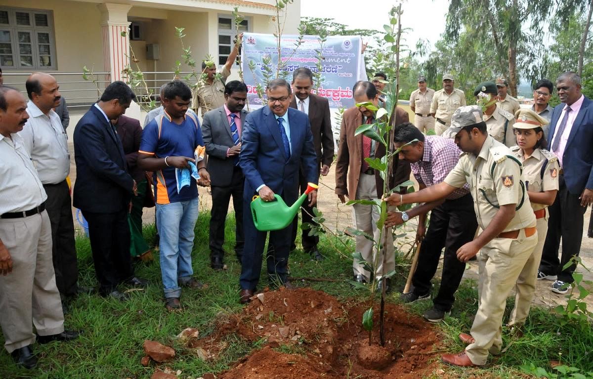 Principal District and Sessions Judge Umesh M Adiga waters a plant on the occasion of the World Environment Day in Chikkamagaluru on Wednesday.