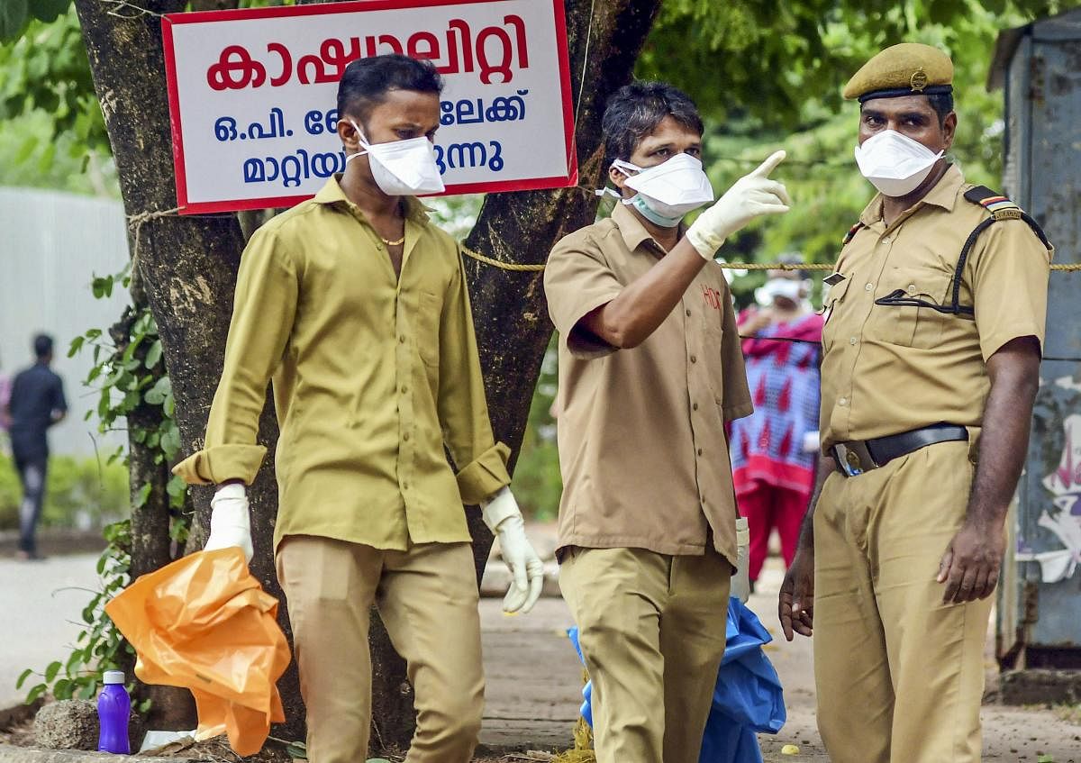 Security officials wear masks as a protective measure after reports of outbreak of Nipah virus, outside the Ernakulam Medical College in Kochi, Tuesday, June 4, 2019. (PTI Photo)