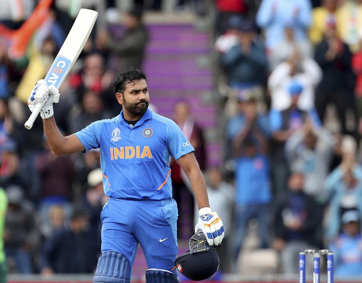 Rohit Sharma raises his bat to celebrate scoring a century during the Cricket World Cup match between South Africa and India at the Hampshire Bowl in Southampton, England, Wednesday, June 5, 2019. (AP/PTI)