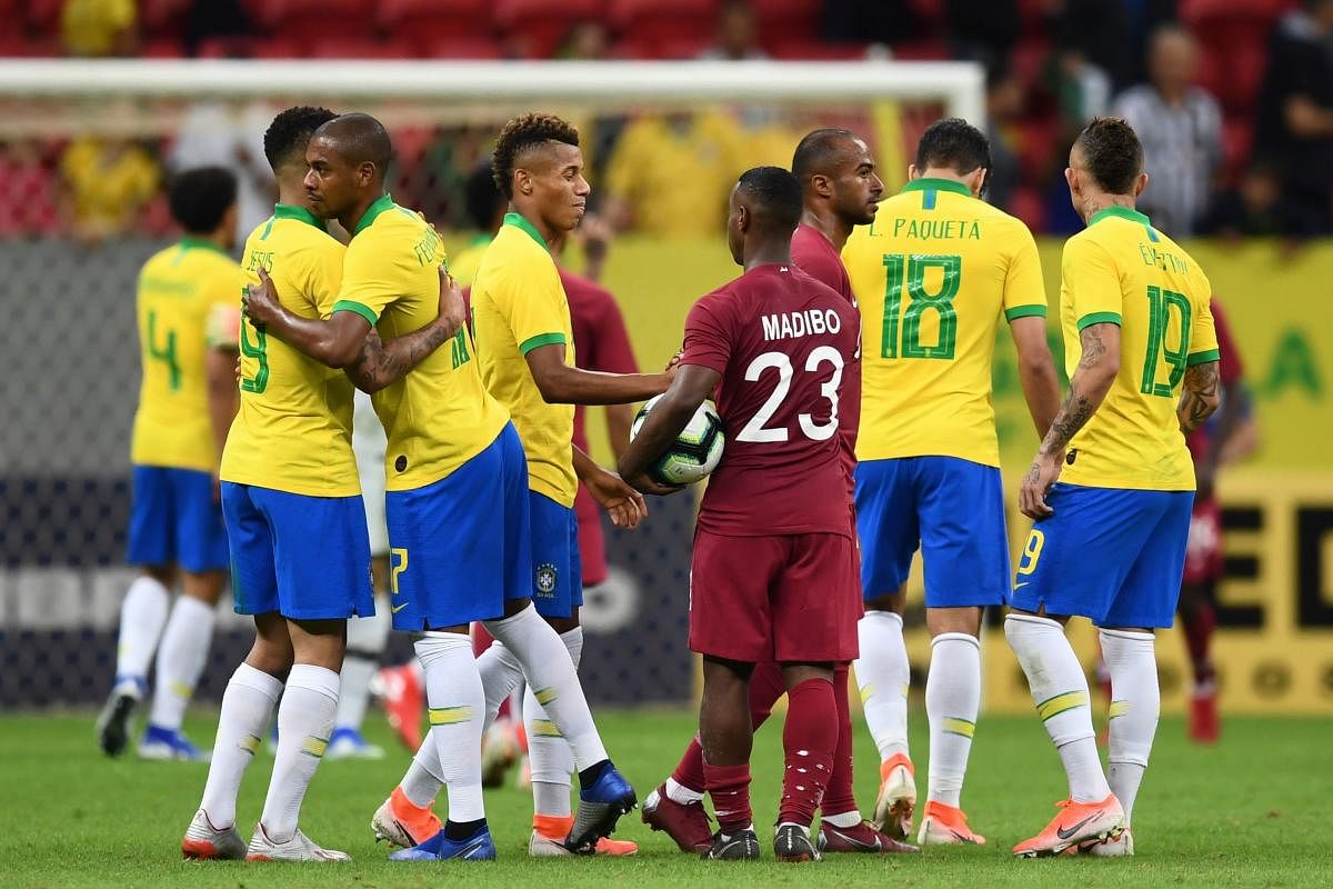 Brazil's players and Qatar's players greet each other at the end of a friendly football match at the Mane Garrincha stadium in Brasilia on June 5, 2019, ahead of Brazil 2019 Copa America. (AFP)